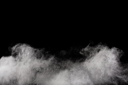 White powder explosion on black background. Colored cloud. Colorful dust explode. Paint Holi.の写真素材
