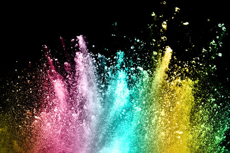 Explosion of colored powder isolated on black background. Abstract colored backgroundの写真素材