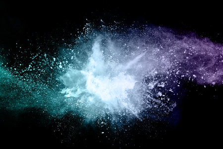 abstract colored dust explosion on a black background.abstract powder splatted backgroundの写真素材
