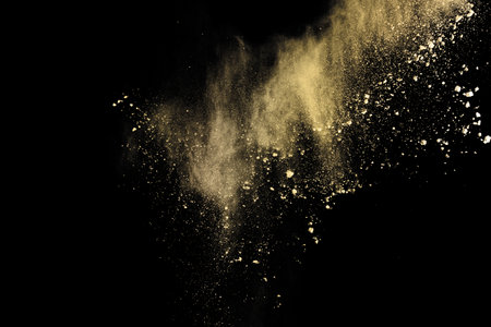 Explosion of yellow powder on black background. Abstract colored cloud.の写真素材