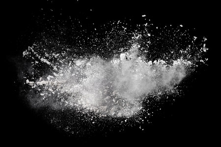 Explosion of white powder isolated on black background. Abstract colored backgroundの写真素材