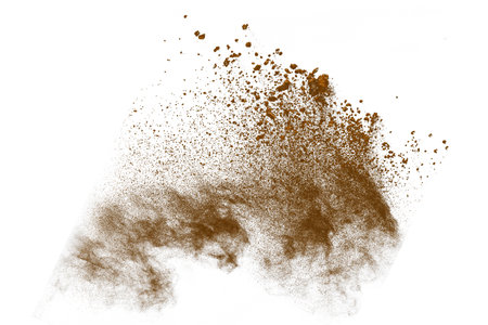 Explosion of brown powder, isolated on white background. Abstract colored designの写真素材