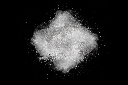 White powder explosion on black background. White powder splash on black background.の写真素材