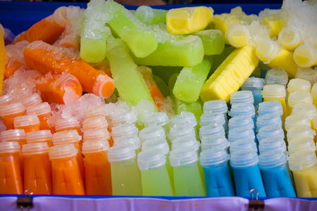 bottles of fruit juice with different colorの写真素材