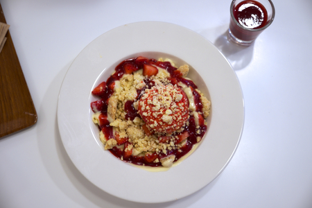 Pancake with strawberry sauce and cookie crumbの写真素材