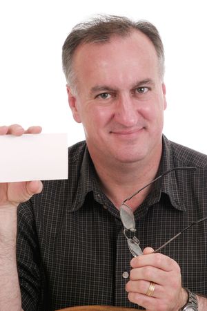 smiling man holding blank white card suitable for text and eyeglasses; isolated on whiteの写真素材