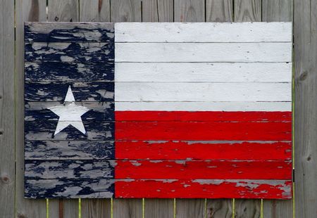 Texas flag made from painted wood slats on a wood fenceの写真素材