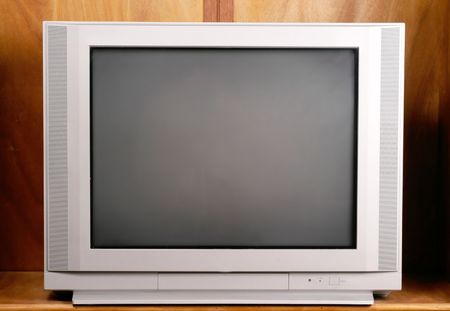 Ordinary and commonplace 27 inch flatscreen television in a wood enclosure cabinet