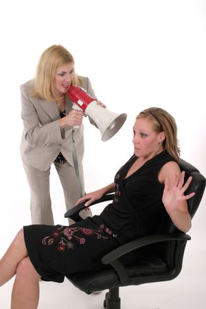 Extreme two person business team with one worker shouting commands through a megaphoneの写真素材