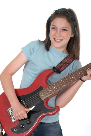 Young pre teen girl playing a red electric guitar.の写真素材