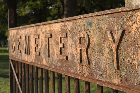Cemetary spelled out in large letters on a sign on the entrance gate to a cemetary.  Focus is on the nearest letter Y.の写真素材