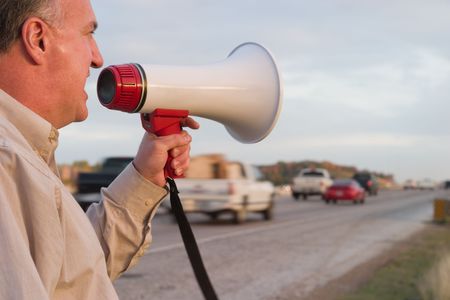 Middle aged man with a serious case of road rage making his feelings known to rush hour traffic!の写真素材