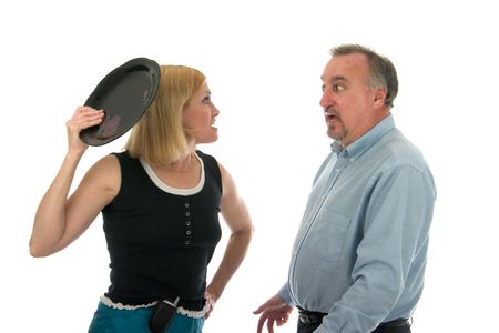 Man and woman in heated argument involving possible flying objects.の写真素材
