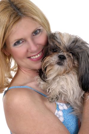Beautiful blonde woman holding Shih Tzu dog.の写真素材