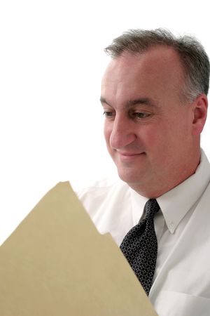 smiling business man reading report in manila folder; isolated on white backgroundの写真素材