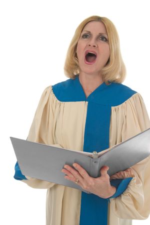 Blond woman in a choir robe holding a music folder and singing.の写真素材
