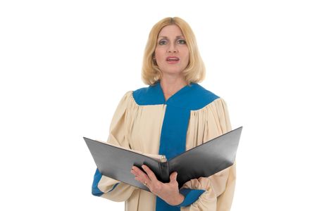 Blond woman in a choir robe holding a music notebook and singing.の写真素材