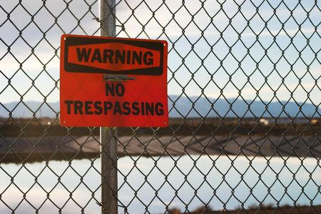 Warning - No Tresspassing Sign on Fence with Colorado Mountains in the background.の写真素材