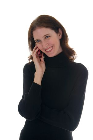 Young brunette woman wearing a black shirt smiling and talking on cell phone.の写真素材