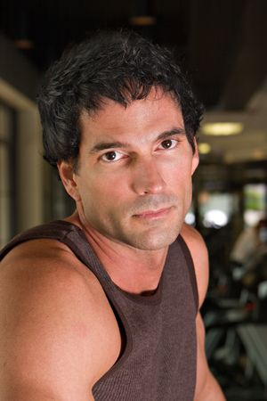 Headshot portrait of a man exercising at a fitness center.の写真素材