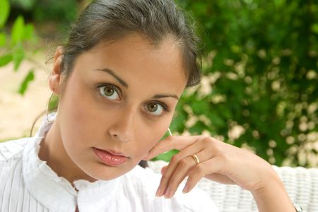 Extreme closeup of a beautiful young brunette woman looking directly into camera.  Shallow depth-of-field with eye and lips in sharp focus.の写真素材