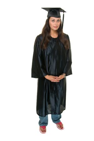 Beautiful young woman standing in graduation robes with bright pink flip flop shoes anxious to graduate.の写真素材