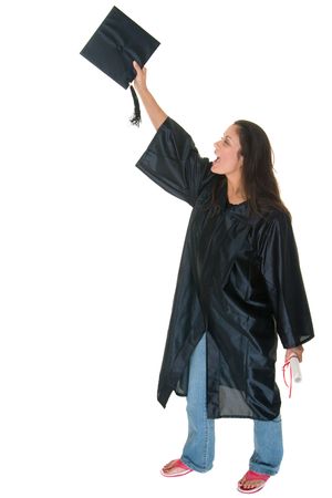 Very happy and proud beautiful young woman standing in graduation robes, cap and gown smiling holding her degree or diploma and throwing her cap in the air. の写真素材