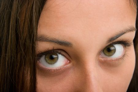 Closeup of a beautiful Hispanic woman looking up to your ad above her in the corner.の写真素材