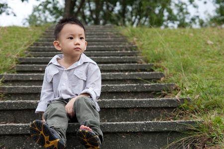 Asian little baby boy poses in a parkの写真素材