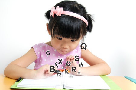 Little girl looks surprise at magic bookの写真素材