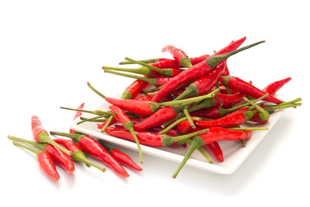 Red chilli in a square plate isolated on white backgroundの写真素材
