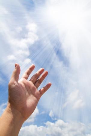 Adult hand reaching out towards the skyの写真素材
