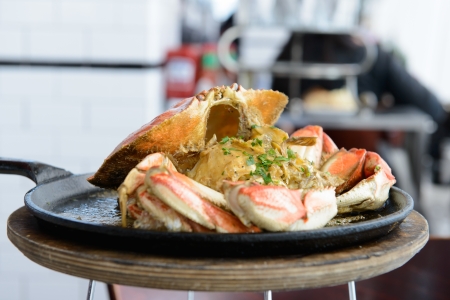 Garlic flavor Dungeness crab served on cook panの写真素材