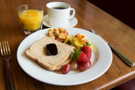 Typical american hearty breakfast of toast, potato, fruits and juice の写真素材