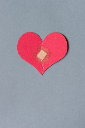 Broken heart combined with a square bandageの写真素材