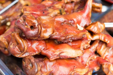 Famous chinese street food roasted pig headの写真素材