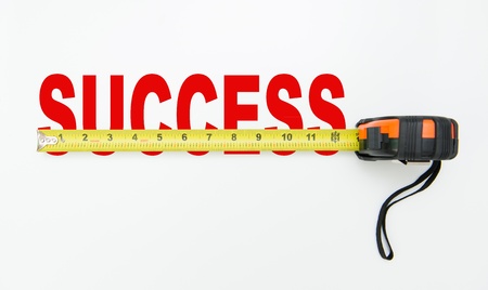 Tape measure over word of success isolated on white background