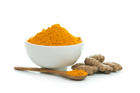 Bowl of turmeric powder with fresh turmeric rootの写真素材