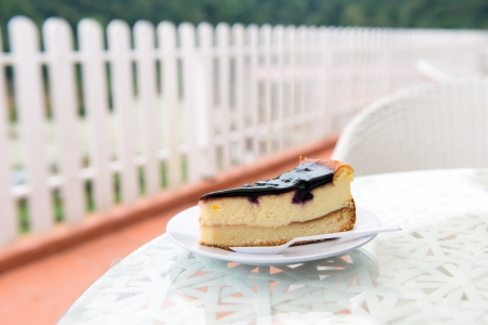 Piece of blueberry cheese cake on white plateの写真素材