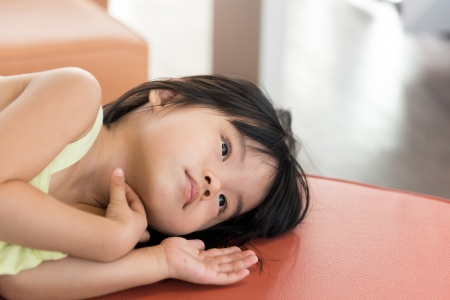 Closeup image of child lying on sofaの写真素材