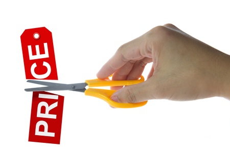 Scissors cutting red price tag on white backgroundの写真素材