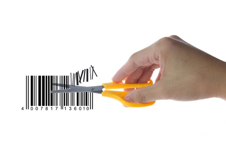 Cutting bar code with scissors on white backgroundの写真素材