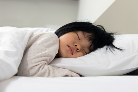 Portrait of Asian child sleeping on the bedの写真素材