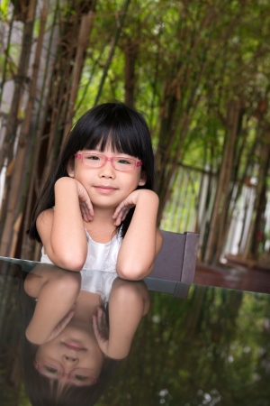 Portrait of little Asian girl with glassesの写真素材