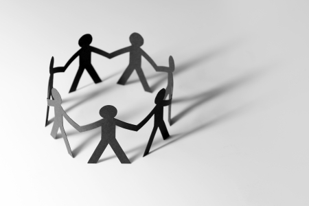 Teamwork concept with people holding hands in a circleの写真素材
