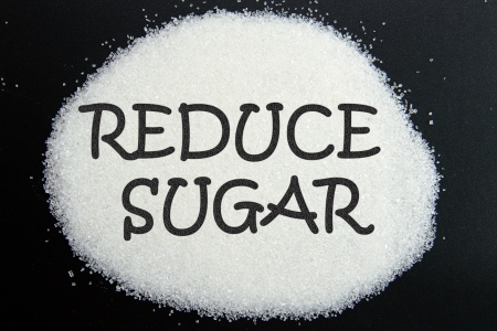 Reduce sugar written on sugar over black backgroundの写真素材