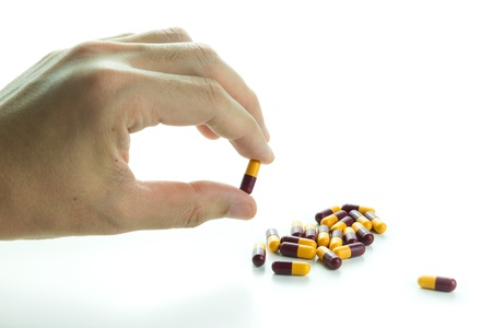 Hand holding medicine isolated on white background