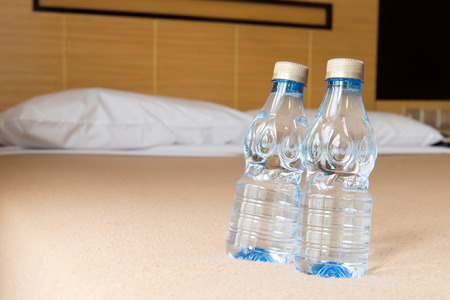 Close up of two mineral water in hotel bedroomの写真素材