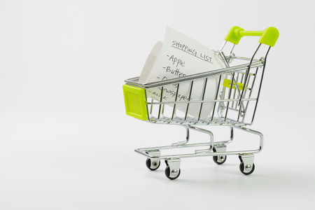 Close up of shopping list inside cart on white backgroundの写真素材