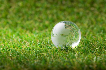 Close up of earth globe in green grassの写真素材